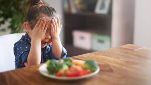 Girl demonstrating picky eating habits, part of article 'Handling Picky Eater Babies