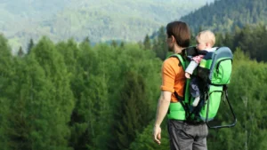 A father and baby hiking in the mountains.